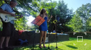 Jazz Zangeres Ann Louise (Janneke Teijen) treedt buiten op in een tuin.